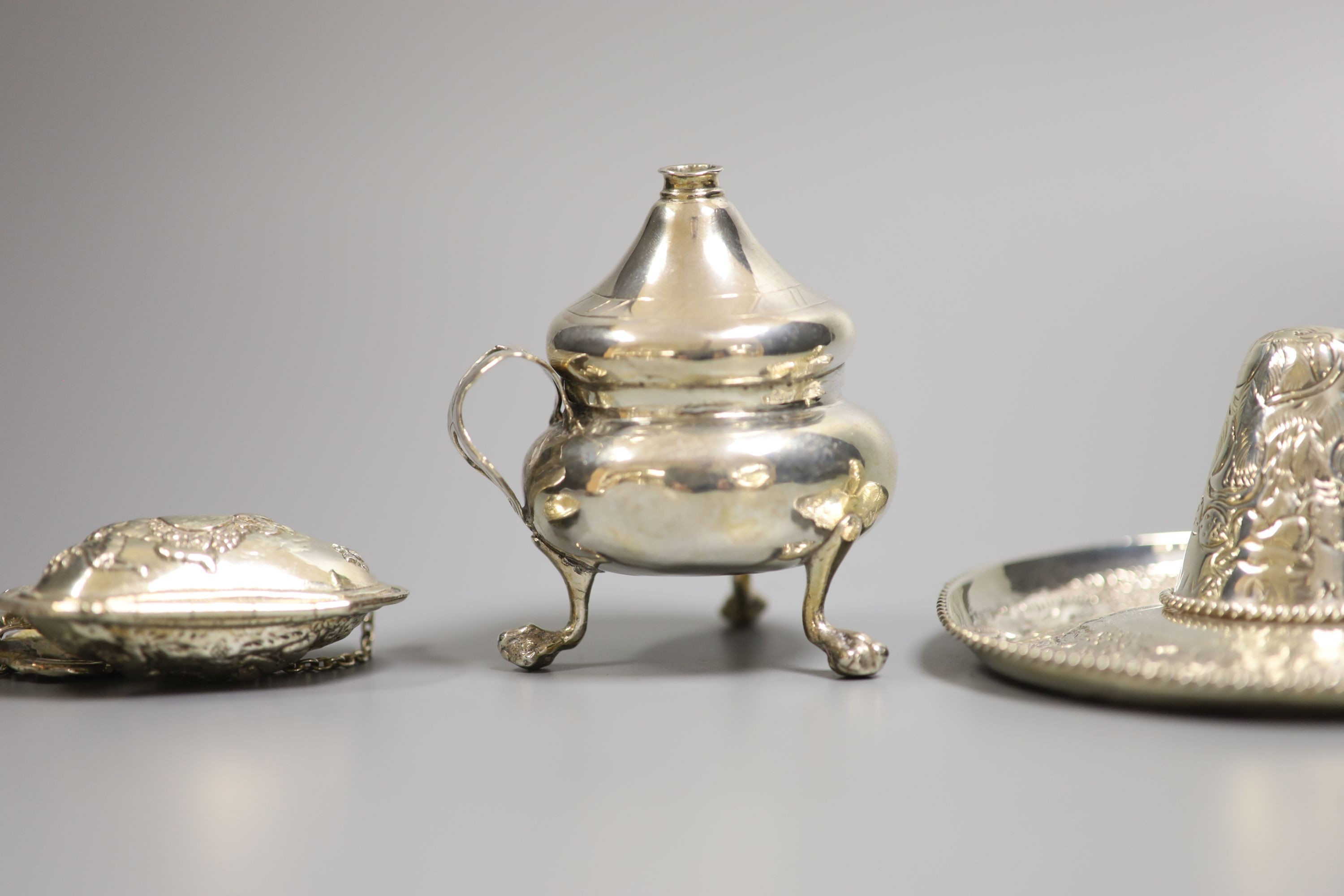 A sterling miniature sombrero and three other items, including candle snuffers and purse